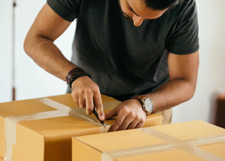 A guy opening a box of goodies. Photo by Ketut Subiyanto