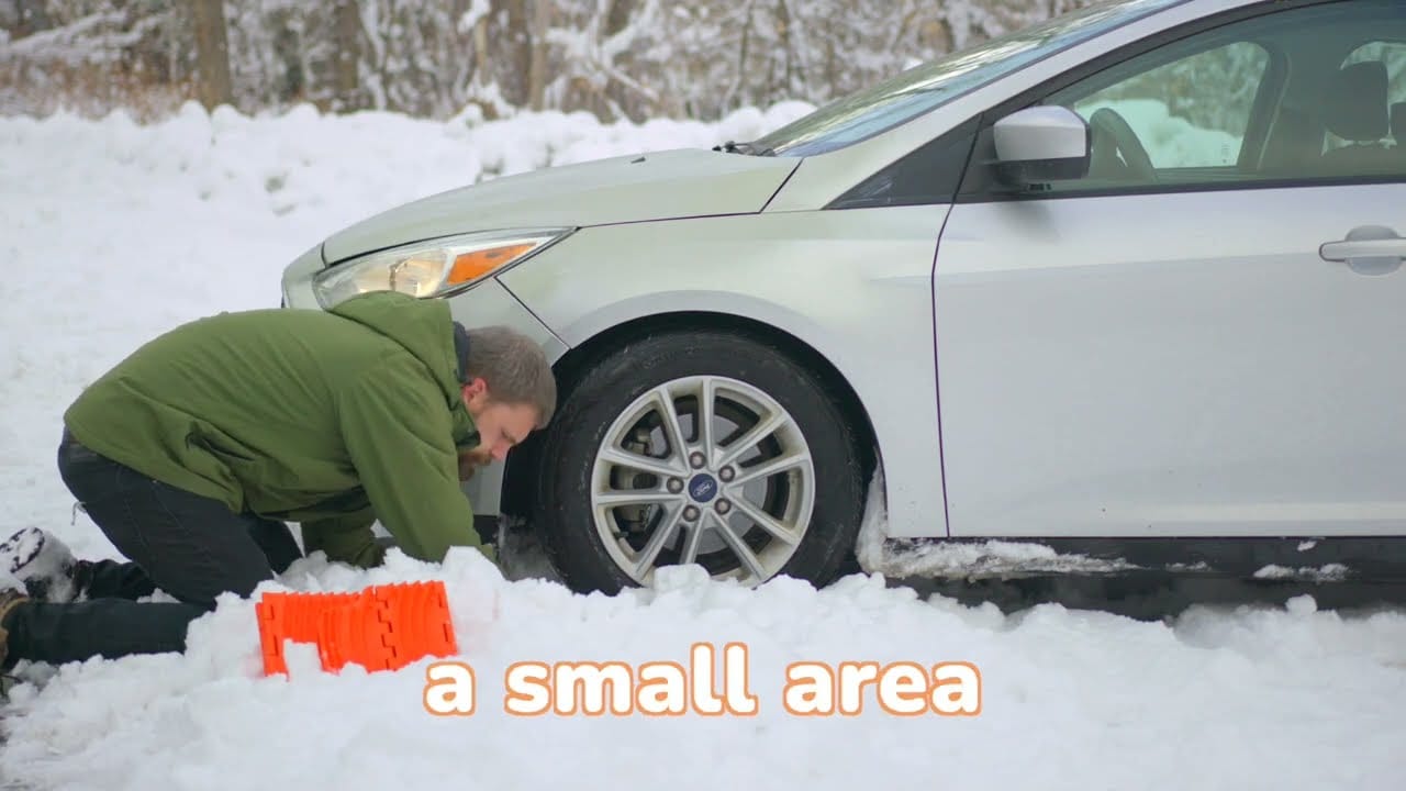 Man working on car in snow with GoTreads